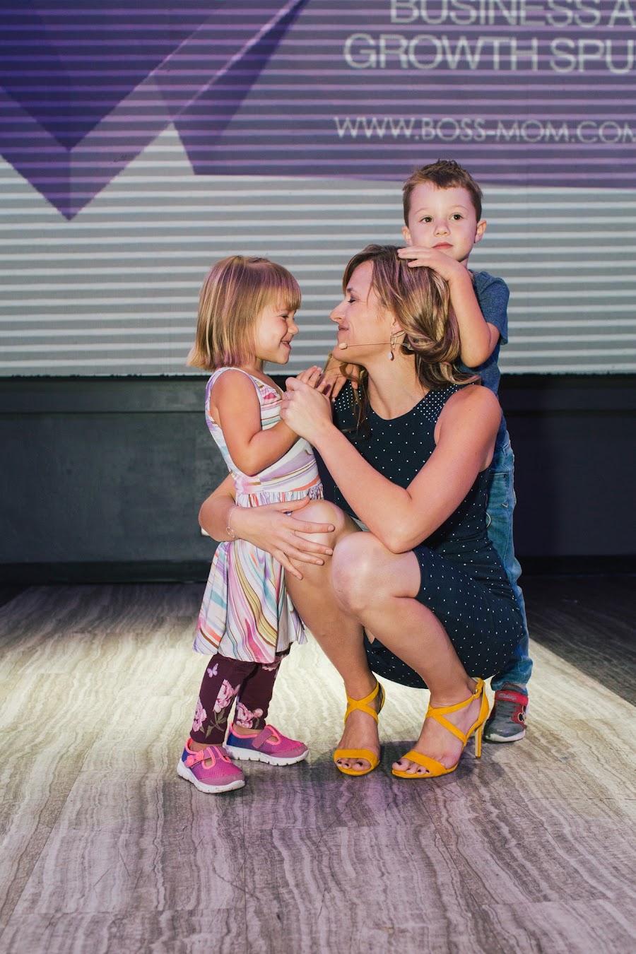 Dana with her kids on the BossMom stage