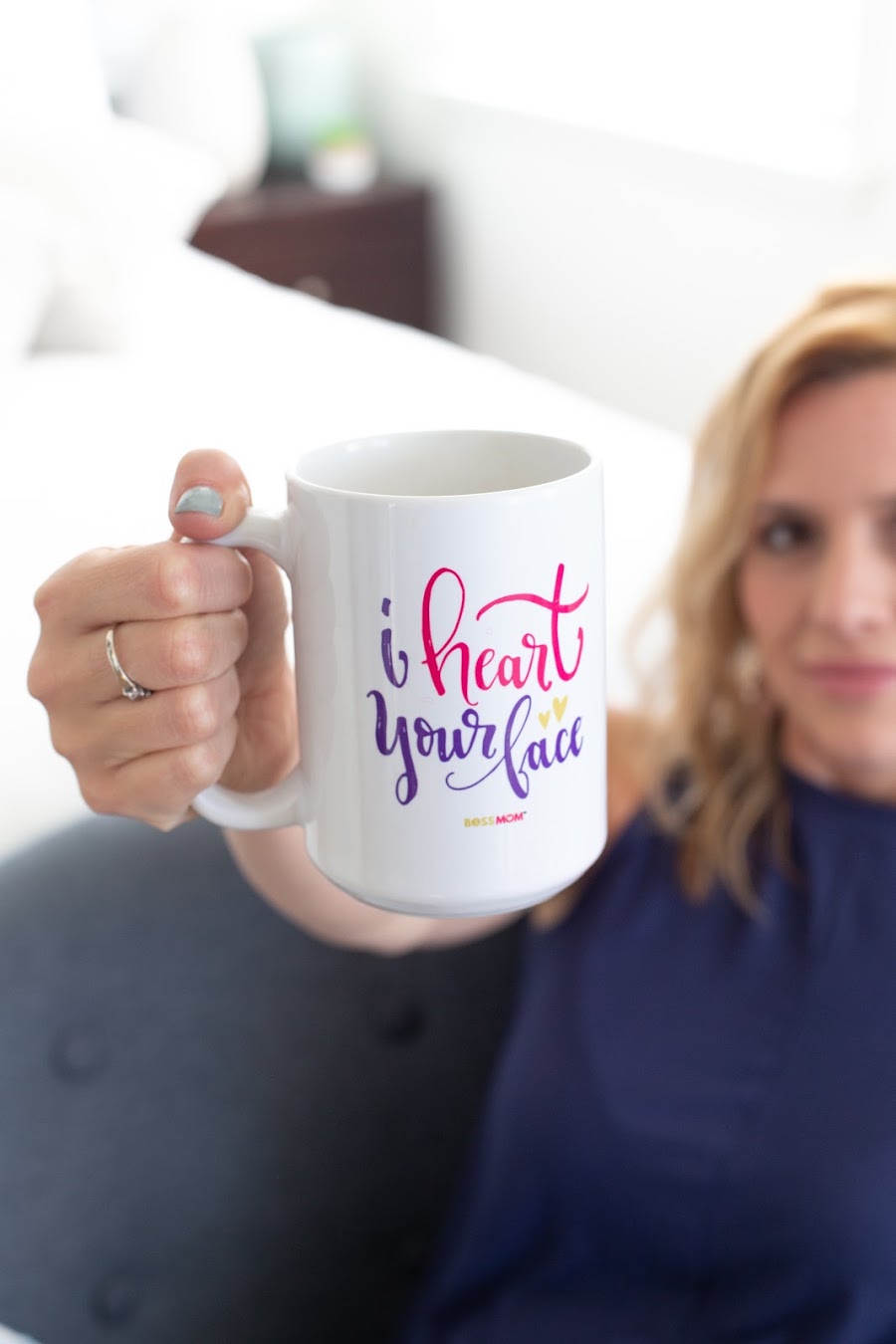 Dana holding up an I heart your face mug