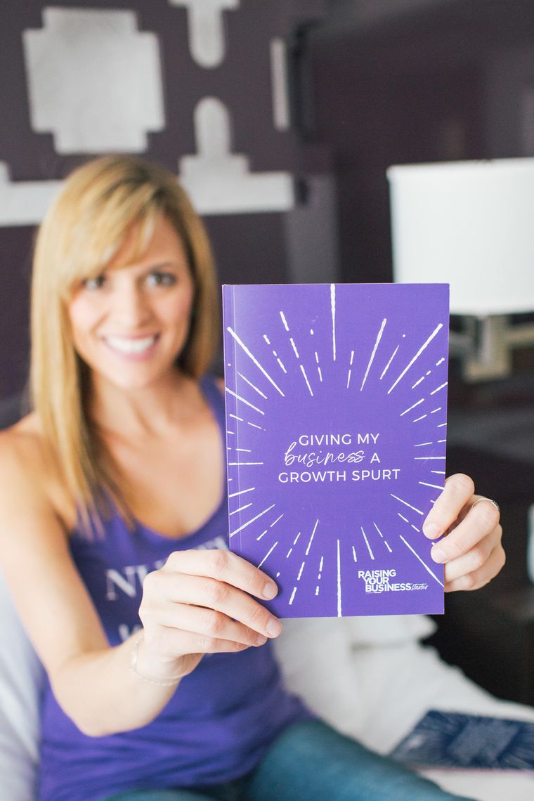 Dana Malstaff smiling and holding a Raising Your Business journal that says Giving my business a growth spurt