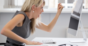 how to overcome perfectionism, woman upset at computer